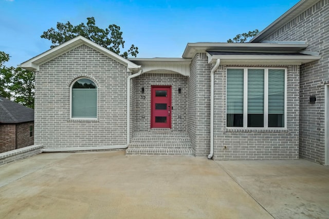 entrance to property featuring a patio