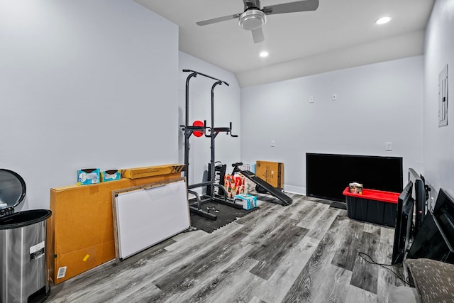 workout room featuring ceiling fan, lofted ceiling, and hardwood / wood-style floors