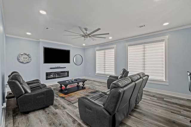 living room featuring ceiling fan, ornamental molding, and hardwood / wood-style floors