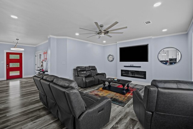 living room featuring ceiling fan, ornamental molding, and hardwood / wood-style flooring