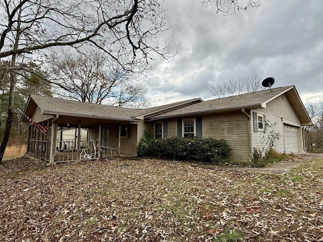 view of front of property with a garage and covered porch