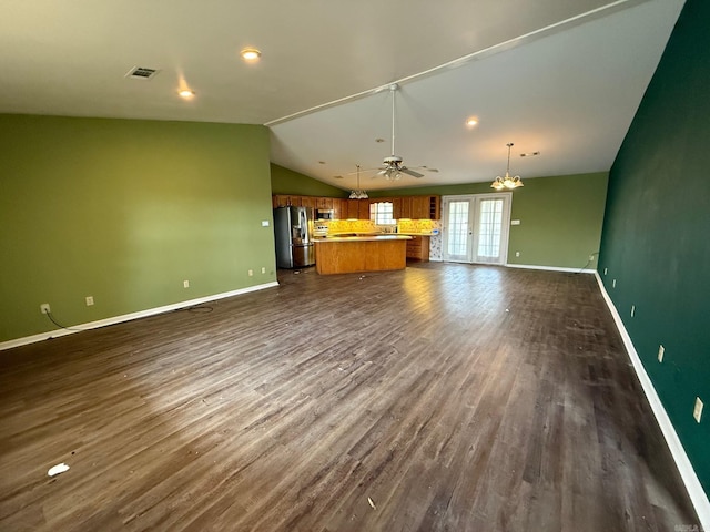 unfurnished living room featuring ceiling fan, lofted ceiling, dark hardwood / wood-style flooring, and french doors