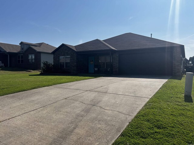 ranch-style home with a garage and a front lawn