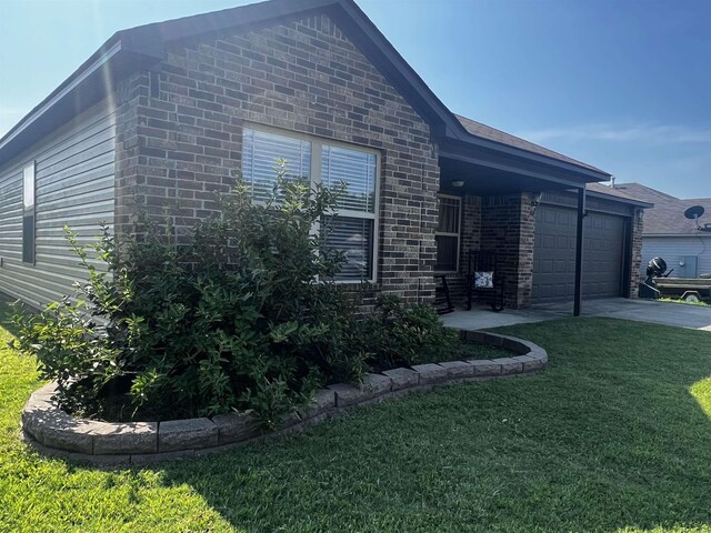 view of front of property featuring a garage and a front lawn