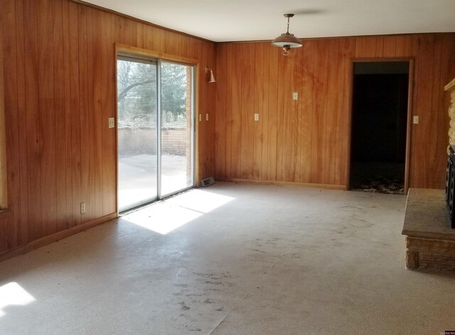 spare room featuring wooden walls