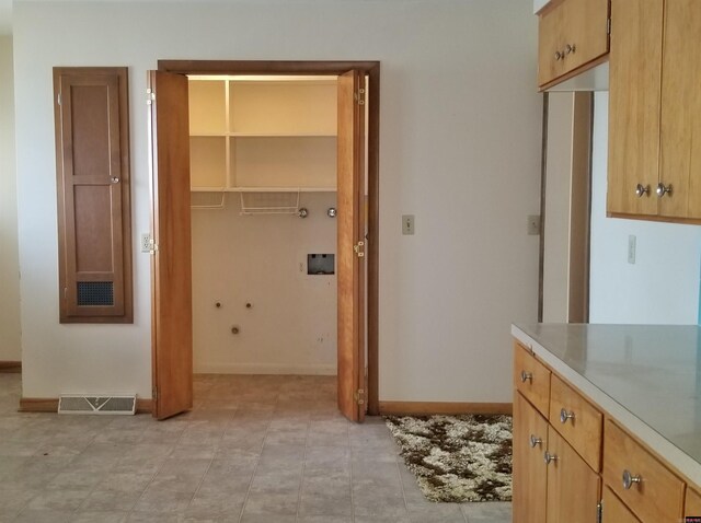 interior space featuring light tile patterned flooring and washer hookup