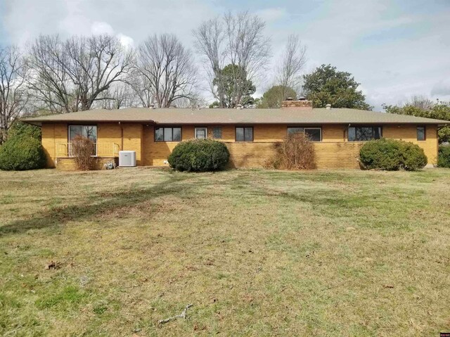 ranch-style house featuring central air condition unit and a front yard