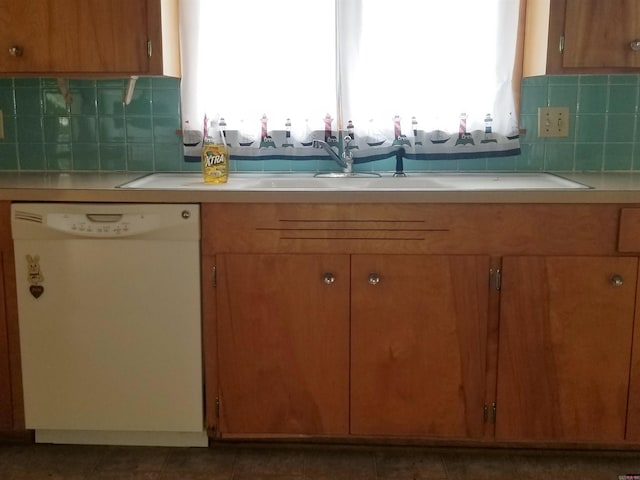 kitchen with tile patterned floors, white dishwasher, and backsplash