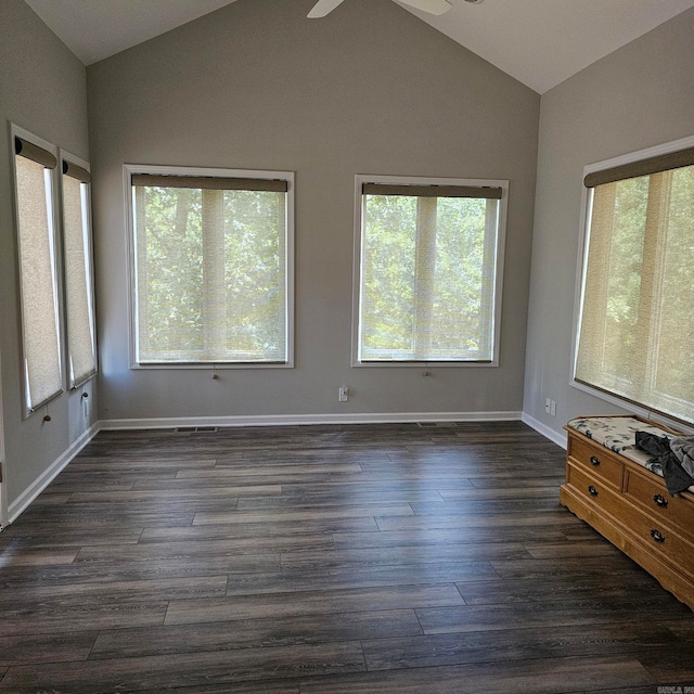 unfurnished room featuring plenty of natural light, ceiling fan, dark hardwood / wood-style flooring, and lofted ceiling