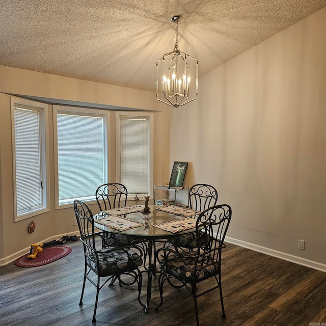 dining space featuring dark hardwood / wood-style flooring, a chandelier, and a textured ceiling