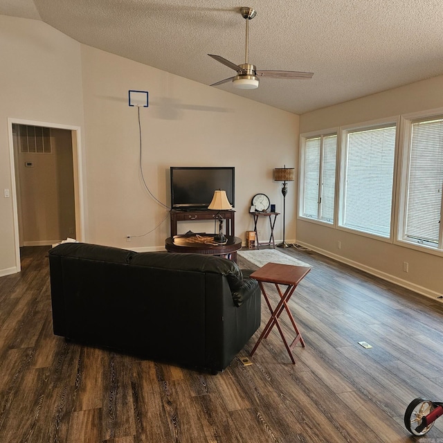 living room featuring dark hardwood / wood-style floors, ceiling fan, vaulted ceiling, and a textured ceiling