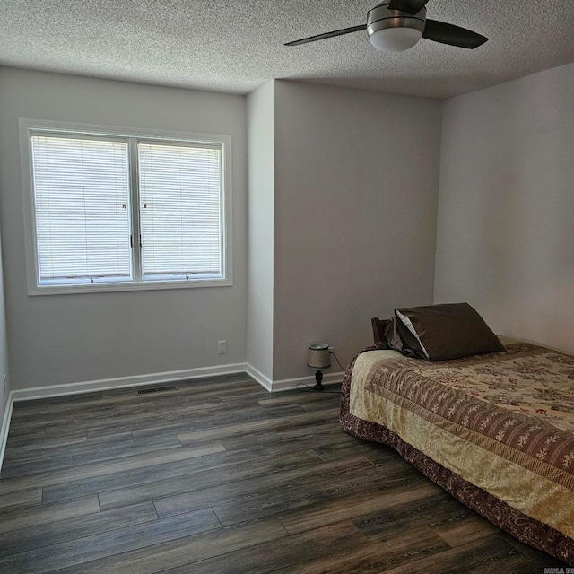 bedroom featuring wood-type flooring, a textured ceiling, and ceiling fan