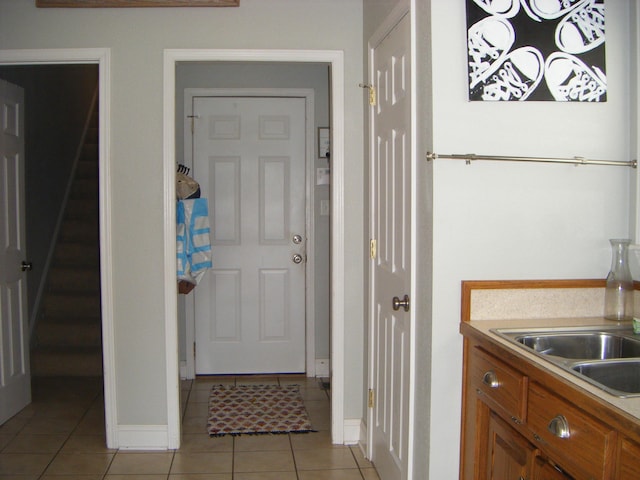 interior space with light tile patterned flooring and sink