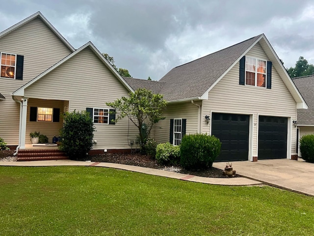 view of front of property with a garage and a front lawn