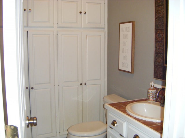 bathroom with toilet and vanity