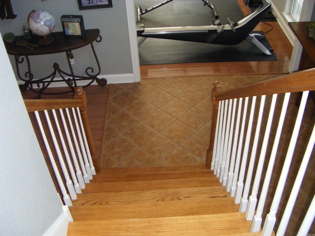 stairway with tile patterned flooring