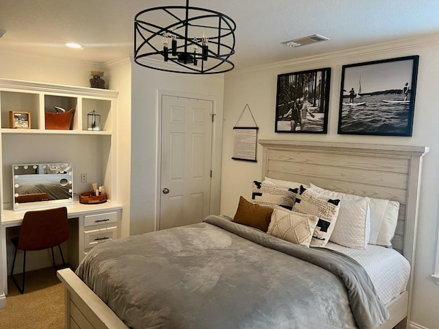 carpeted bedroom with ornamental molding and built in desk