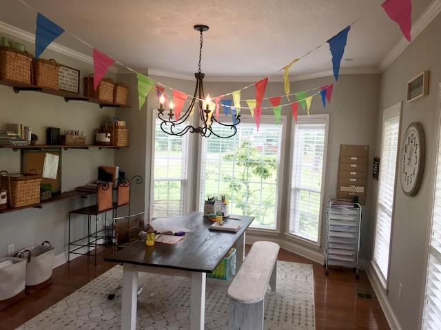 dining room featuring dark wood-type flooring, crown molding, and a chandelier