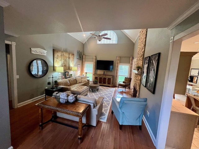 living room featuring ceiling fan, ornamental molding, hardwood / wood-style floors, and high vaulted ceiling