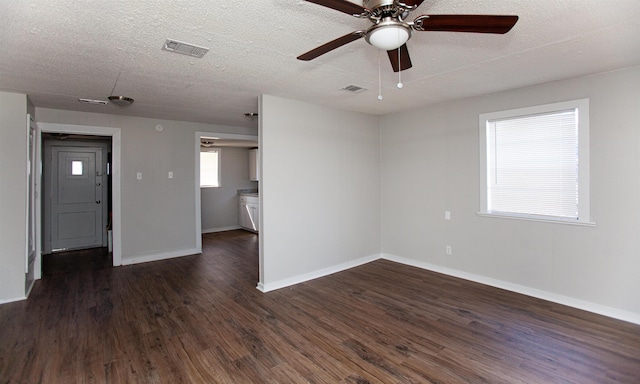 spare room with ceiling fan, dark wood-type flooring, and a textured ceiling