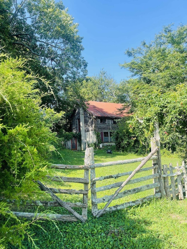 view of gate featuring a yard