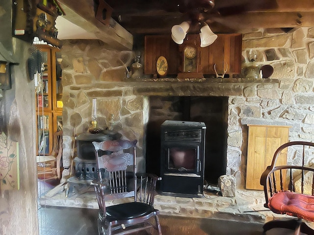 room details featuring ceiling fan and a wood stove