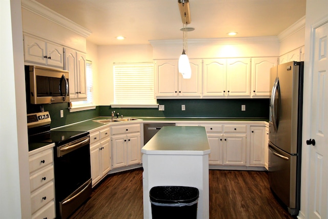 kitchen featuring white cabinetry, appliances with stainless steel finishes, a center island, and decorative light fixtures