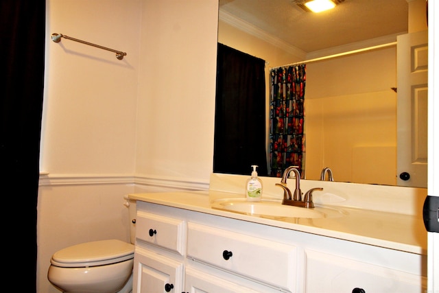 bathroom with crown molding, walk in shower, vanity, and toilet