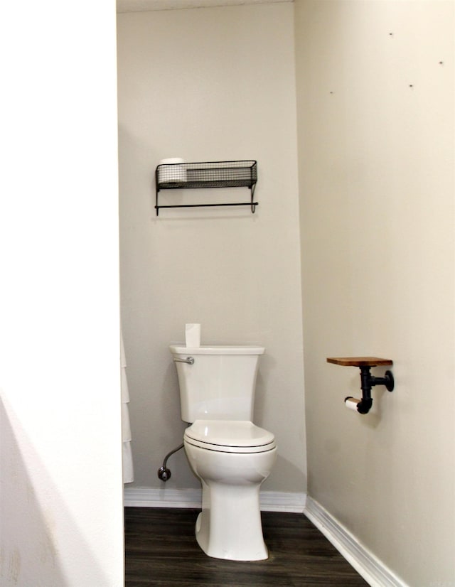 bathroom featuring wood-type flooring and toilet