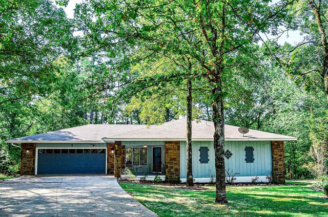 single story home with a front yard and a garage