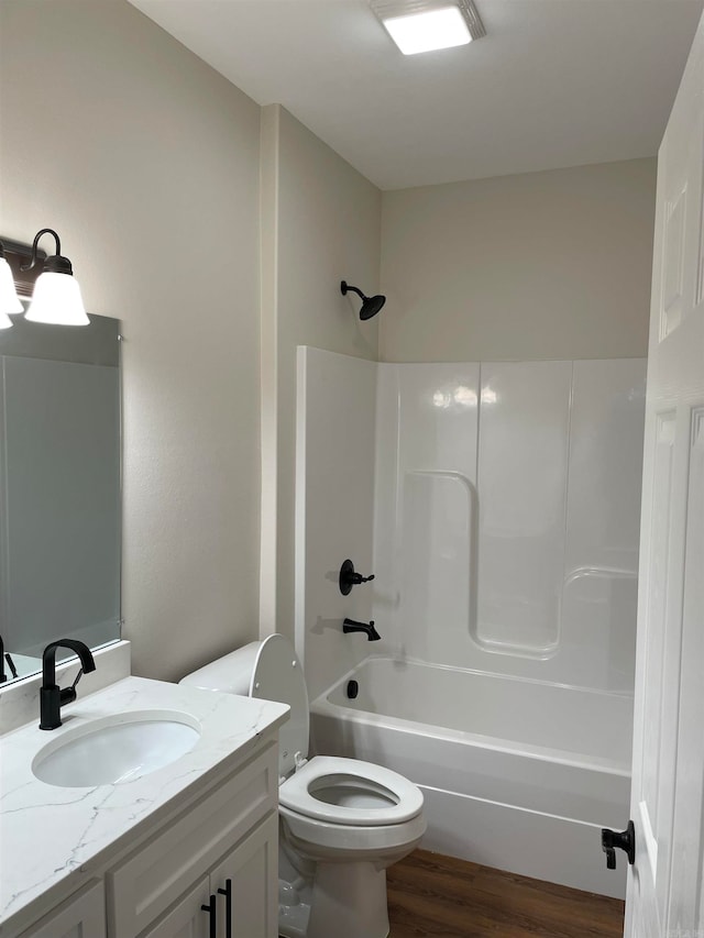 bathroom featuring shower / bathing tub combination, vanity, toilet, and wood finished floors