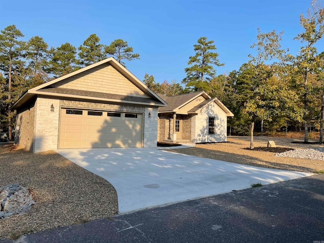 view of front of property with driveway, brick siding, roof with shingles, and an attached garage