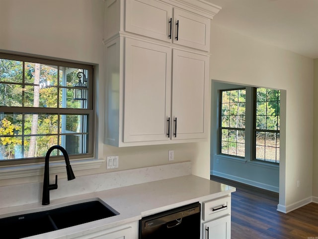 kitchen featuring dark wood finished floors, light countertops, white cabinetry, a sink, and dishwasher