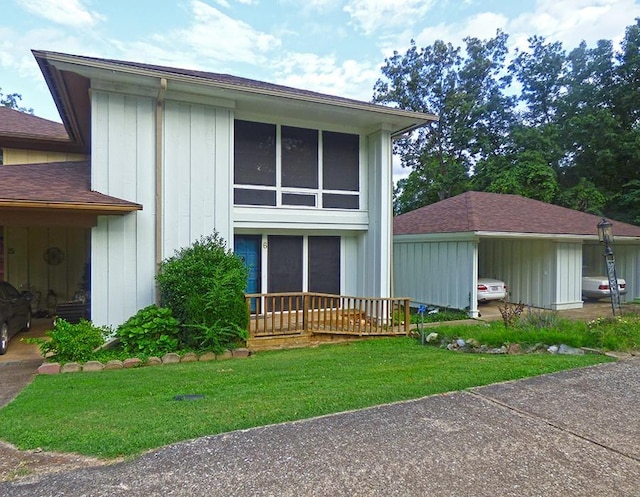 view of front of house with board and batten siding and a front yard