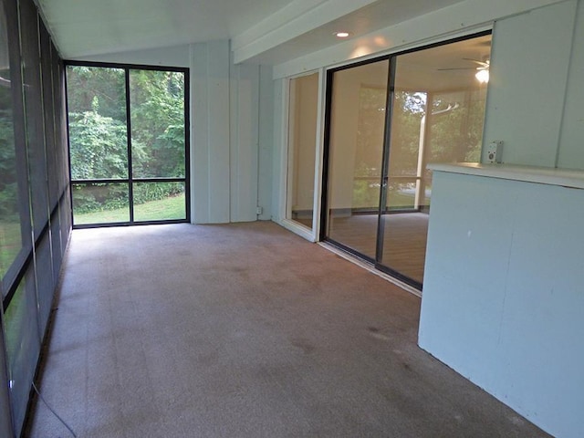 unfurnished sunroom with vaulted ceiling and a ceiling fan