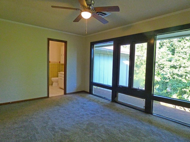 unfurnished room with ornamental molding, carpet, visible vents, and a ceiling fan