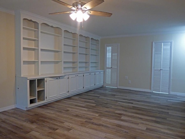 interior space featuring dark wood-type flooring, crown molding, baseboards, and a ceiling fan