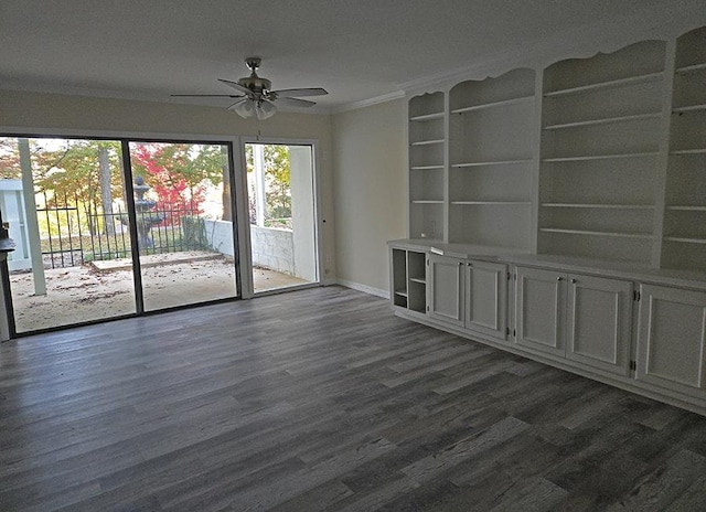 empty room with a ceiling fan, baseboards, ornamental molding, and dark wood-type flooring