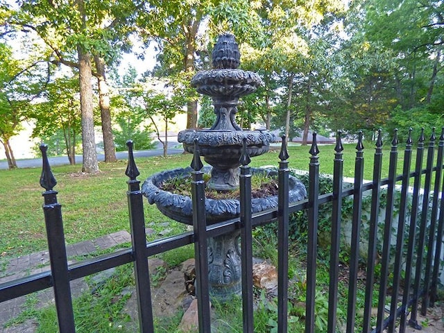 view of gate with a yard