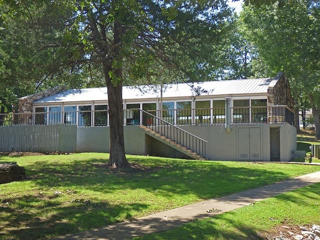 view of front of home featuring a front yard and stairway