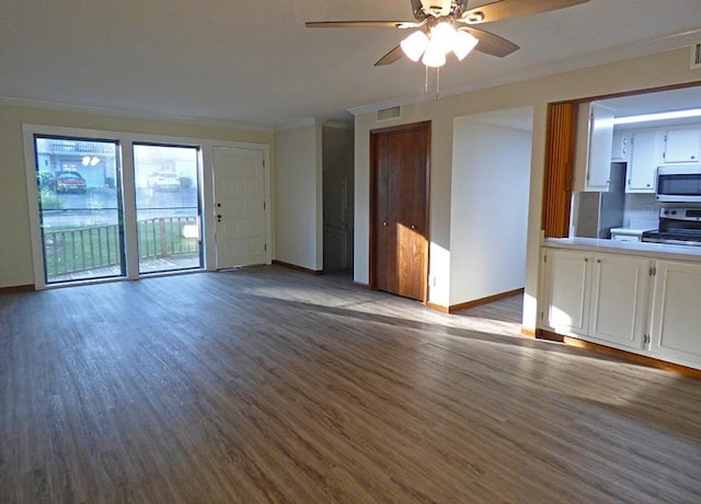 unfurnished living room with baseboards, visible vents, crown molding, and wood finished floors