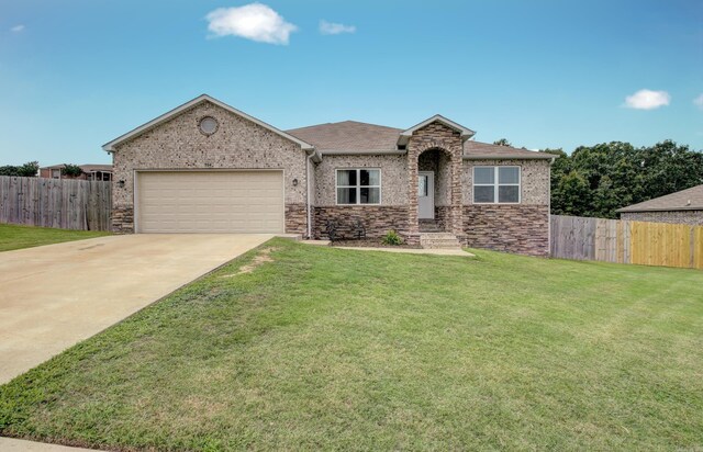 view of front facade with a garage and a front lawn