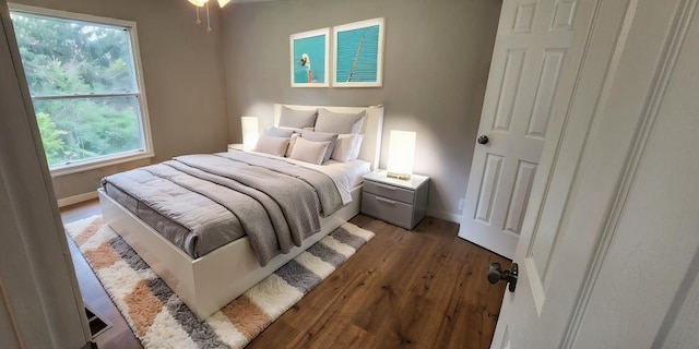 bedroom featuring hardwood / wood-style flooring and multiple windows