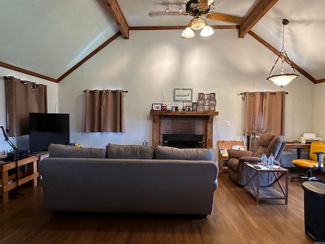 living room featuring ornamental molding, beamed ceiling, hardwood / wood-style flooring, and a fireplace