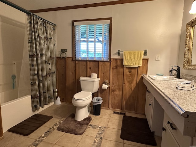 full bath featuring toilet, a wainscoted wall, wood walls, vanity, and shower / bath combo