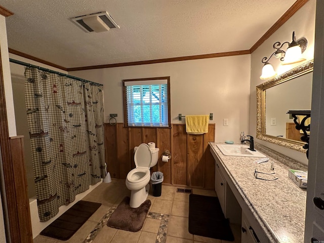 bathroom featuring vanity, a textured ceiling, crown molding, wooden walls, and toilet