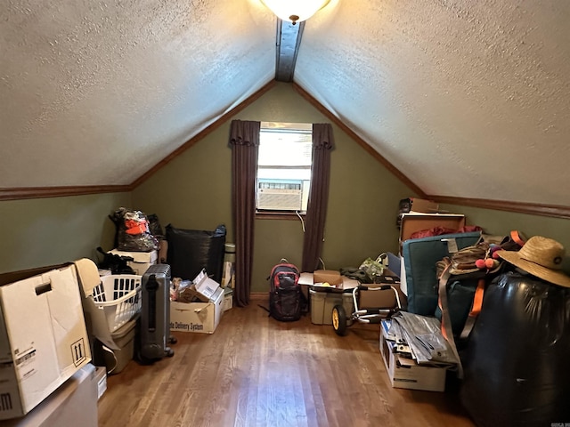 bonus room with lofted ceiling, a textured ceiling, cooling unit, and wood finished floors