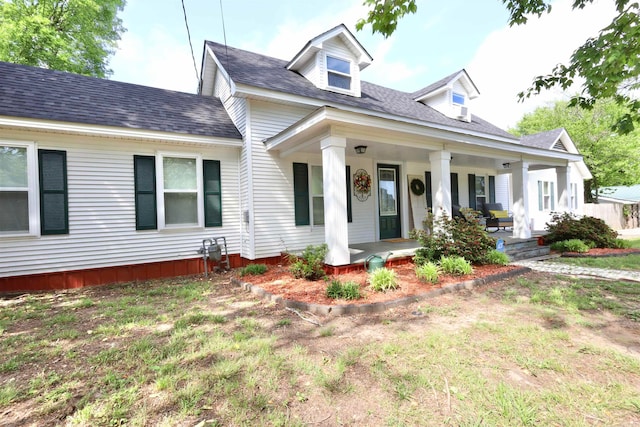 new england style home featuring covered porch