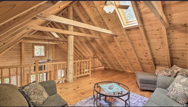 bedroom featuring a closet, ceiling fan, beamed ceiling, and wood walls