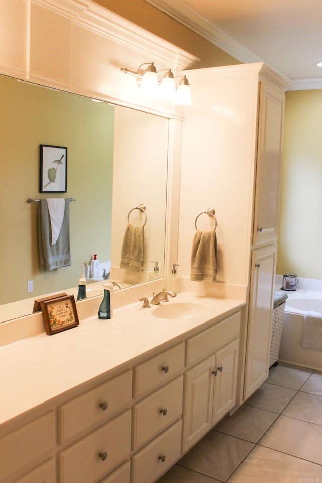 bathroom featuring vanity, tile patterned flooring, ornamental molding, and a tub